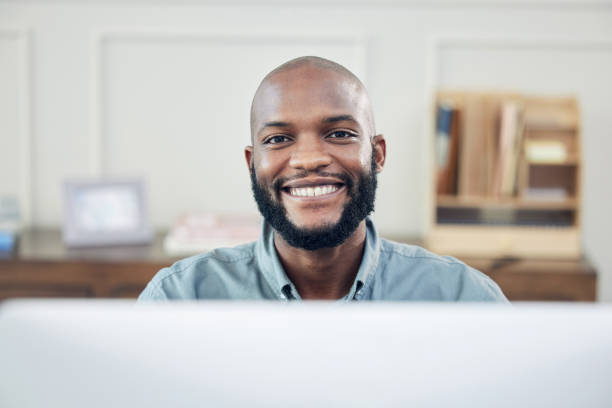 istock Shot of a handsome young businessman sitting alone in his office and using his computer 1345930936