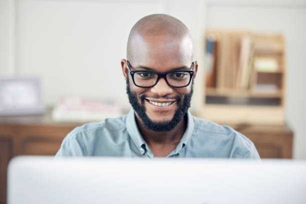 istock Shot of a handsome young businessman sitting alone in his office and using his computer 1345930943