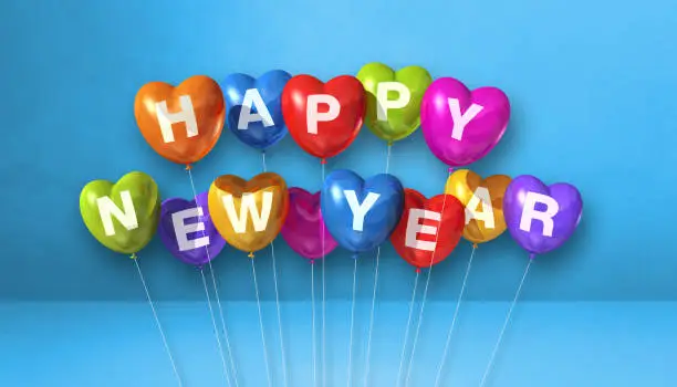 Colorful happy new year heart shape balloons on a blue concrete background. Horizontal banner. 3D illustration render