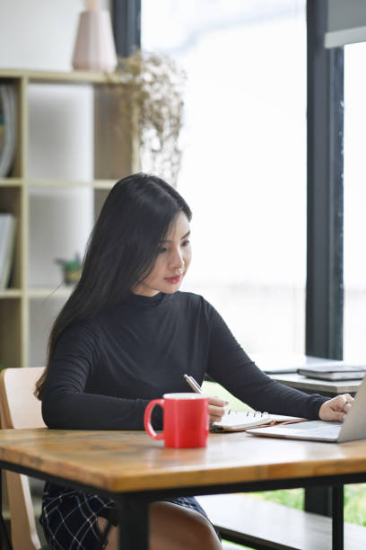 istock Attractive creative woman working in modern workplace. 1345933019