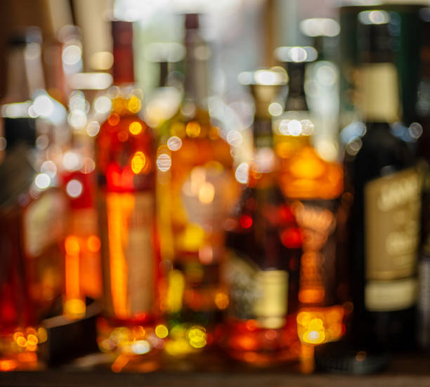 istock Beautiful bokeh from a row of alcoholic bottles in backlight. 1345935117