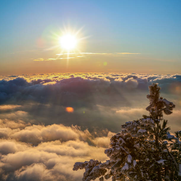 istock Sunrise shining over the clouds.  Beautiful cloudscape and sunrise in th mountains. 1345935538