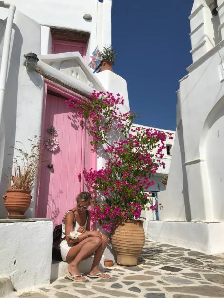 istock Young woman cuddling stray cat in Greece 1345935688