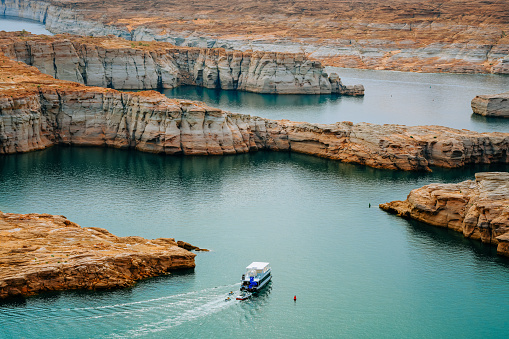 Houseboat on Lake Powell in Utah, long beautiful coastline on background