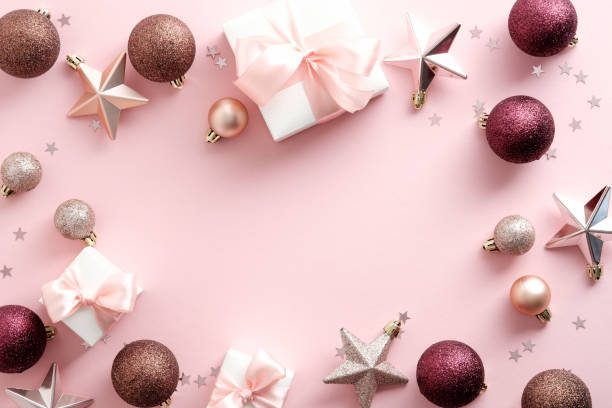 istock Elegant Christmas flat lay composition with Christmas decorations, balls, gift boxes, stars on pastel pink background. Beauty blog Christmas banner design. Flat lay, top view. 1345936439