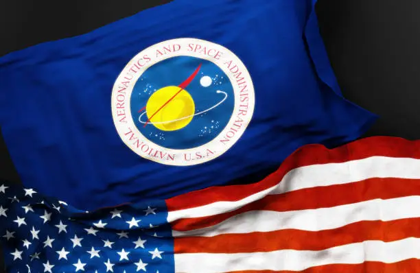 Flag of the United States National Aeronautics and Space Administration along with a flag of the United States of America as a symbol of a connection between them, 3d illustration.