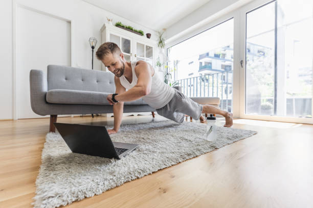 istock Handsome man working out at home 1345938632