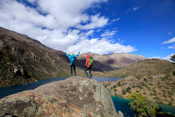 istock Two women backpackers hiking  in beautiful winter mountains 1345938678