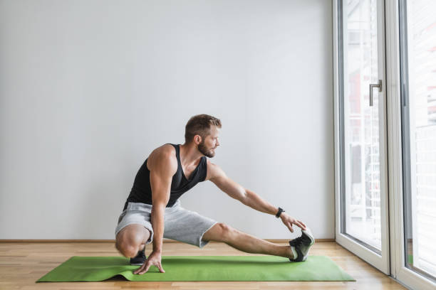 istock Handsome man working out at home 1345938770