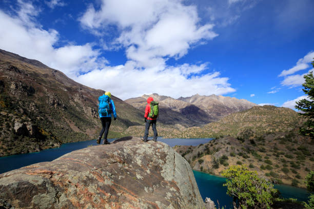 istock Two women backpackers hiking  in beautiful winter mountains 1345938793