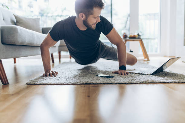 istock Handsome man working out at home 1345939034