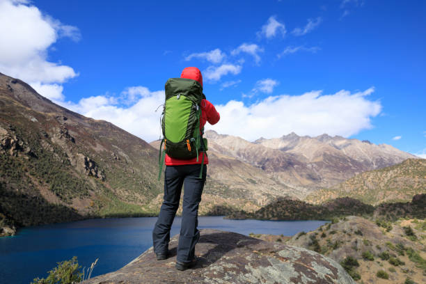 istock Woman backpacker hiking in beautiful winter mountains 1345939761
