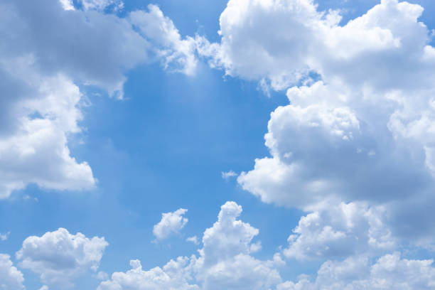 Beautiful white fluffy clouds on vivid blue sky in a sunny day upward view photo and copy space stock photo