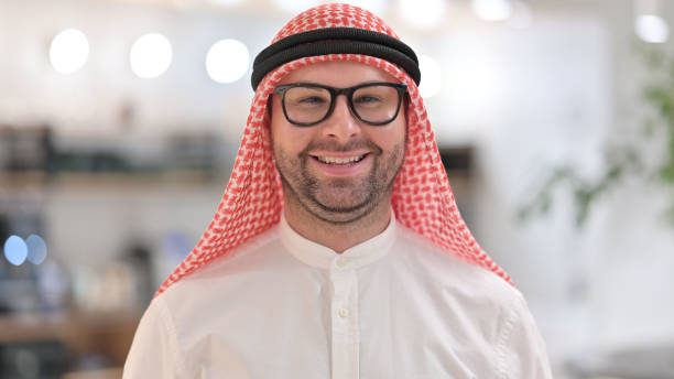 istock Portrait of Smiling Young Arab Man Looking at Camera 1345941341