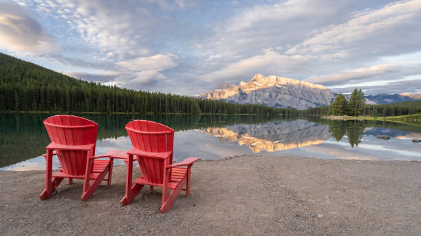 istock Peaceful sunrise lookout for two with mountain reflecting in lake´ s surface 1345942348