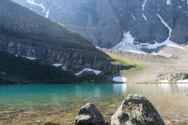 istock Beautiful turquoise alpine lake surrounded by mountains 1345942407