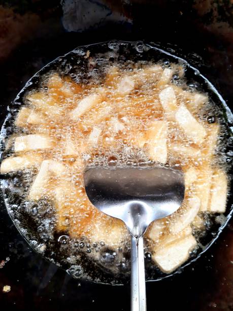 istock Frying Taro in boiling cooking oil. 1345943325