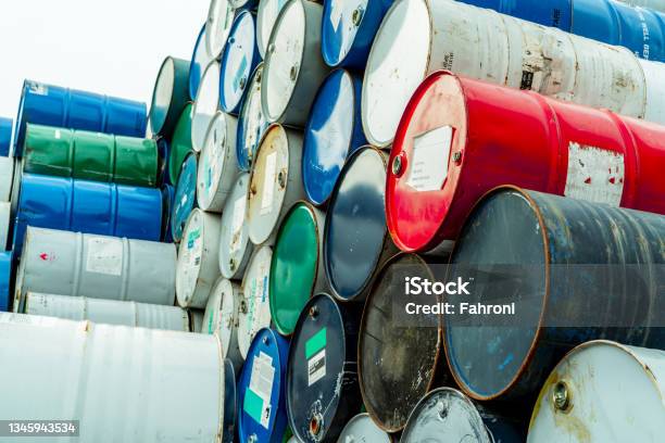 Old Chemical Barrels With Flammable Liquid Warning Label Steel Oil Tank Toxic Waste In Metal Tank Hazardous Chemical Barrel Hazard Waste Storage In Factory Chemical Barrels Stack Oil Brent Stock Photo - Download Image Now