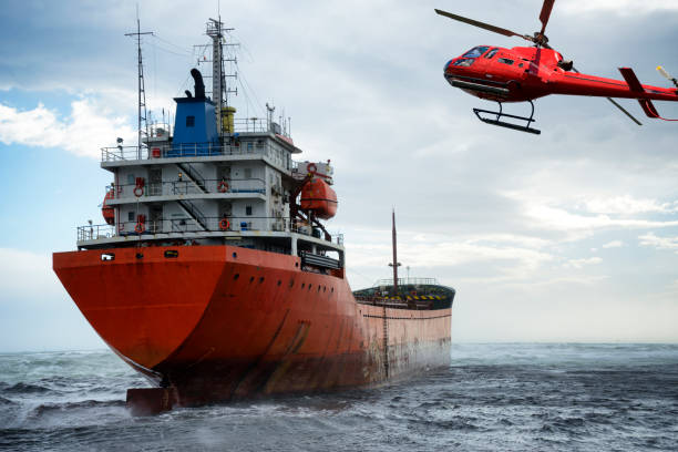 istock Cargo ship run aground on the shore and helicopter. 1345946123