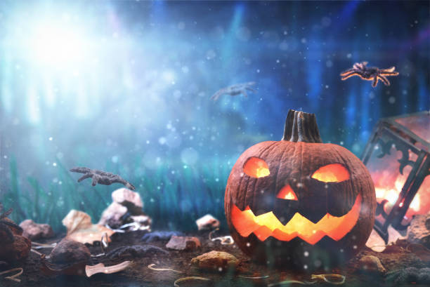 istock Background halloween pumpkin with spiders at night in forest blue 1345947129