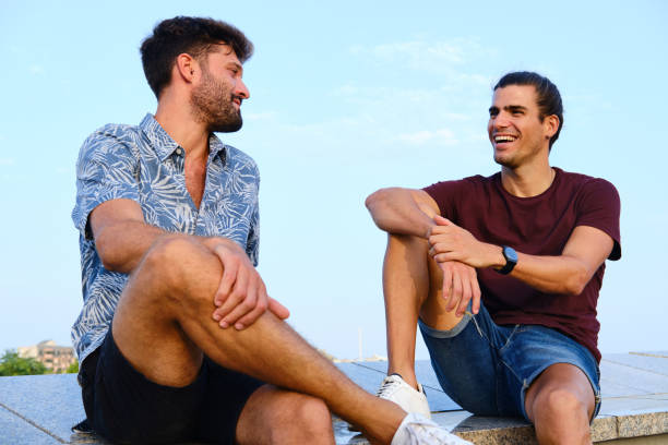 istock Two friends sitting and talking outdoors. 1345947263