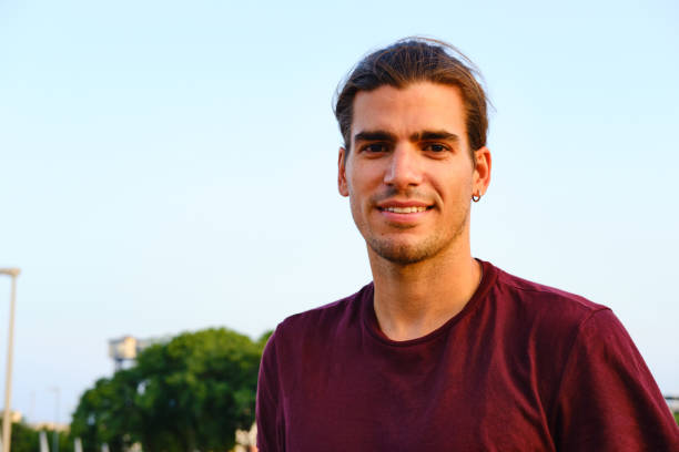 istock Young man looking at the camera outdoors. 1345947280