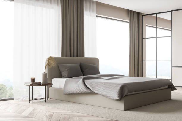 istock Corner of beige bedroom with panoramic windows 1345948445