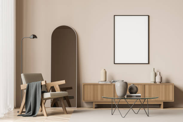 istock Empty canvas on wall of beige seating area with armchair 1345948949