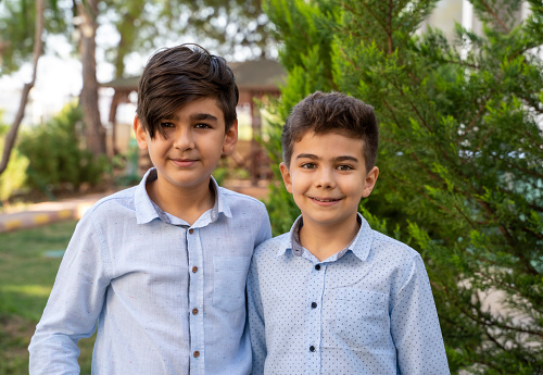 Two young brothers outdoor portrait