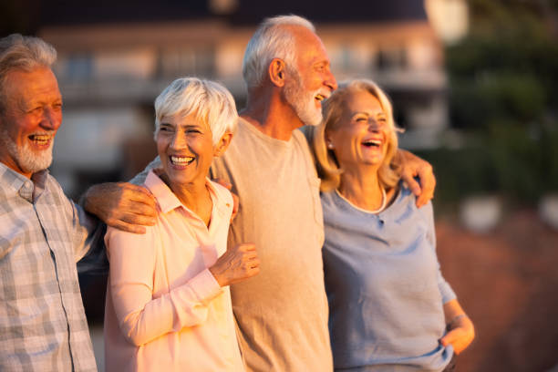 istock Cheerful senior friends walking embraced in nature. 1345949109
