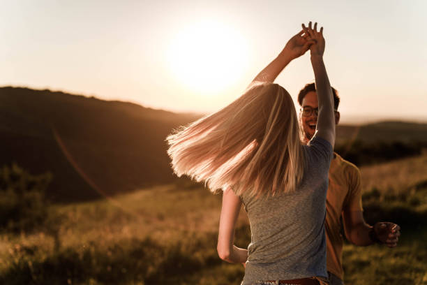 istock Young romantic couple enjoying in their dance during springtime at sunset. 1345949901