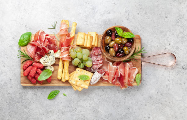 istock Antipasto board with prosciutto, salami, crackers, cheese, olives 1345949973