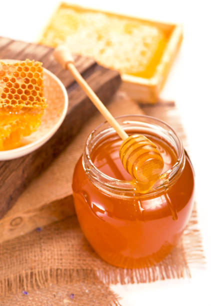istock glass pot with floral honey isolated on white background 1345949985