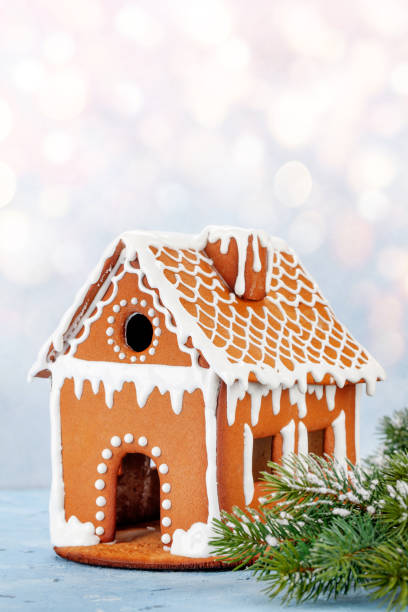 istock Christmas greeting card with gingerbread house 1345950099