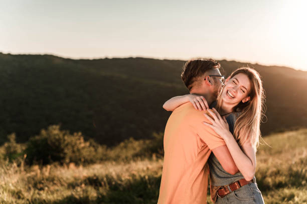istock Young affectionate couple embracing in spring day outdoors. 1345950268