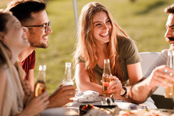 istock Happy friends enjoying in conversation during spring day in nature. 1345950510