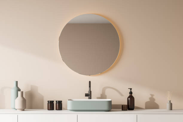istock View of green bathroom sink with round mirror 1345951004