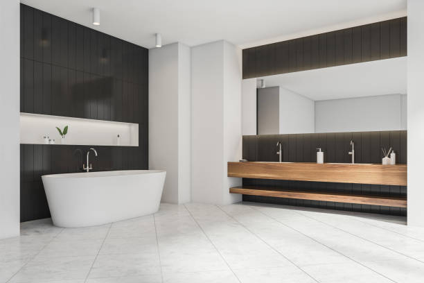 istock Minimalist white and black bathroom space with wooden vanity. Corner view. 1345951848