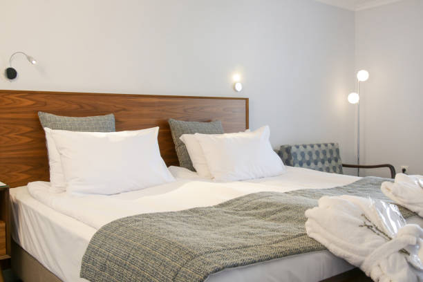 istock Simple and cozy bedroom with king size bed in neutral tones. 1345952151