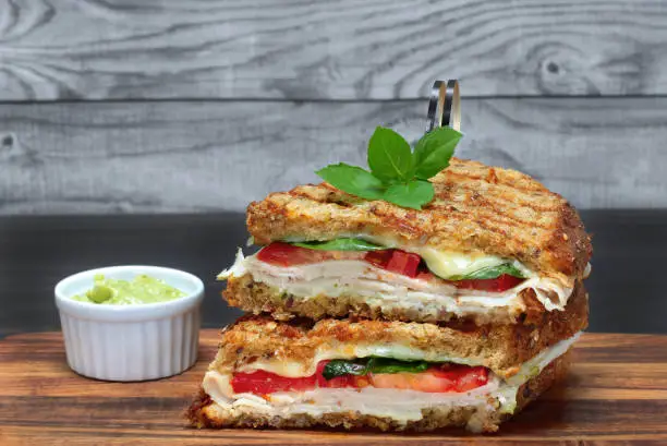 One stacked turkey,tomato, basil, spinach and cheese panini on multi grain bread with basil mayo on the side.  Macro