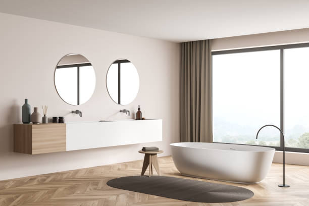 istock Modern beige panoramic bathroom with two round mirrors. Corner view. 1345952598