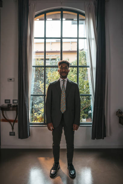 istock Businessman posing agaist a bit window in the office 1345953195