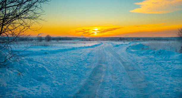 istock The beautiful sunset with tracks in snow winter background 1345953311