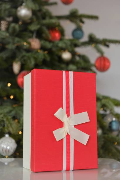 istock Christmas presents. Red gift boxes on Christmas tree background. New Years holiday 1345953474