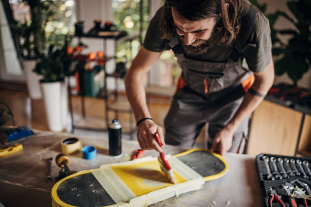 istock Man painting skateboard 1345953780