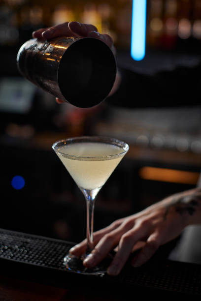 istock male barman hands is making cocktail with steel shaker 1345954754
