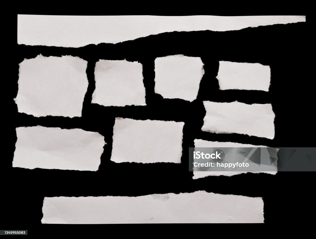 Torn papers Torn white papers on black background Newspaper Stock Photo