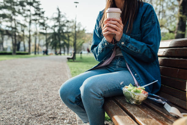 istock Girl drinking coffee and having a salad for lunch 1345957068