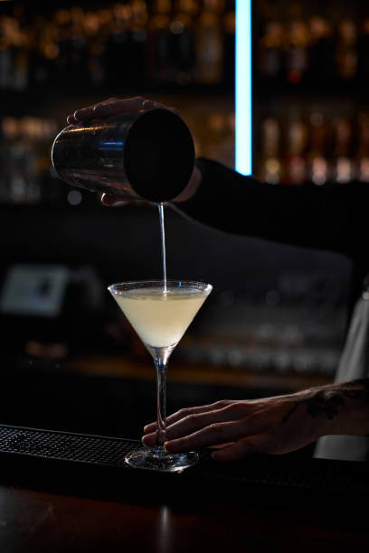 istock male barman hands is making cocktail with steel shaker 1345957573