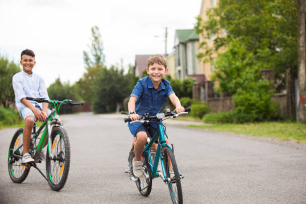 istock Portrait Of Smiling Boy Riding Bicycle 1345958112